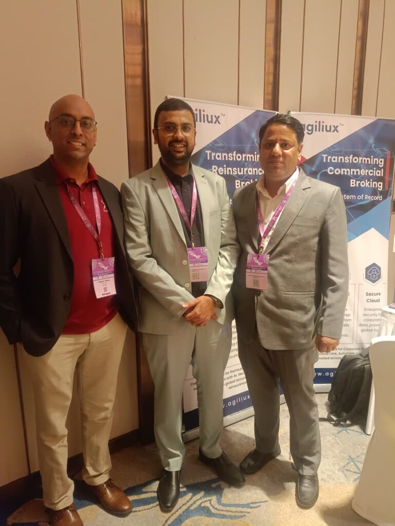 Agiliux representatives interacting with insurance leaders at the event